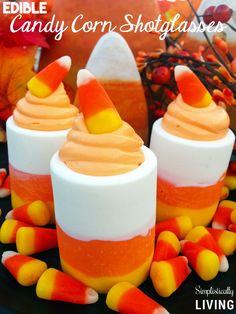 three candy corn shot glasses on a plate