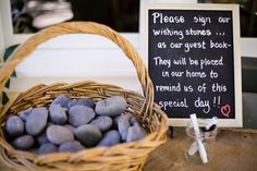 a basket filled with rocks next to a sign