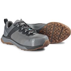 a pair of gray hiking shoes on a white background