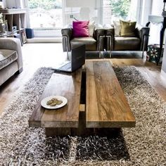 a living room with two couches and a coffee table in the middle of it