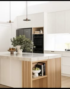 a kitchen with white cabinets and an island