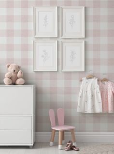 a baby's room with pink furniture and pictures on the wall, including a teddy bear