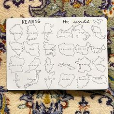 a notepad with the words reading around the world written in black ink on it