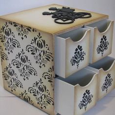 three storage bins with black and white designs on them