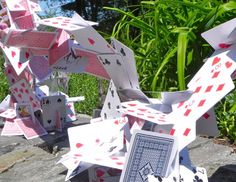 some cards are sitting on top of each other in front of trees and bushes,