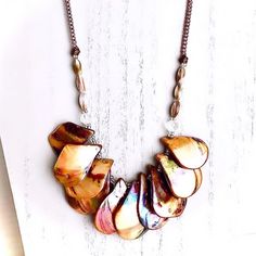 an image of a necklace with shells on it