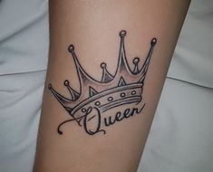 a woman with a crown tattoo on her arm and the word queen written in cursive font