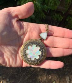 This beautiful locket is made with Baroque and Rococo eras in mind.  The bronze plated copper has been antiqued to bring out intricate details. The center carefully made to look like a blue iridescent moonstone or opal.  It is framed by a scalloped lace edge Victorian style medallion.  The light dances over it and the colorful flash is amazing. It is connected to an 18 inch bronze chain with a triangle bezel. The locket opens up to hold your special treasures inside.   This is a beautiful gift f Baroque And Rococo, Photo Locket, Scalloped Lace, Lace Edging, Locket Necklace, Rococo, Victorian Fashion, Favorite Things Gift, Antique Bronze