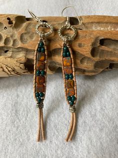 "These long hanging Boho Style earrings are Opaque Yellow Picasso Czech Glass Tile beads. They have been accented with very rich teal colored Seed Beads. They have accented with a silver tone TierraCast hammered ring, and finished off with a silver crimp bead, all which has been beaded onto warm beige tone leather. There is a silver tone french earwire for ease of wearing. These earrings measure just about 4-3/8\"inches long, which includes the attached earwire. See picture. They are 3/8\" inch wide on the beaded portion, and the TierraCast ring is 1/2\" inch wide. These are very lightweight, and move freely. Shipping is free in the US! Thanks so much for looking!" Boho Earrings Diy, Boho Jewelry Diy, Boho Chic Earrings, Boho Style Earrings, Hammered Ring, Warm Beige, Macrame Design, Ear Rings, Hanging Earrings