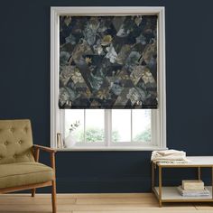 a living room with blue walls and a window covered in floral roman blind coverings