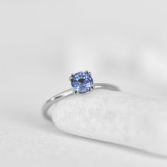 Experience the captivating beauty of our solitaire ring featuring a stunning light blue sapphire. This versatile piece is perfect for any occasion, whether as a classic engagement ring or an everyday accessory that breaks the routine. The delicate hue of the gemstone is accentuated by the ring's exquisite craftsmanship, creating a unique charm that's both understated and elegant. Its timeless design and captivating beauty make it an exceptional addition to any collection. Classic Blue Sapphire Ring In 14k White Gold, Blue Solitaire Topaz Ring Round Cut, Blue Topaz Solitaire Ring Round Cut, Minimalist Blue Sapphire Promise Ring, Classic Sapphire Solitaire Topaz Ring, Classic Blue Topaz Solitaire Ring, Minimalist Blue Sapphire Ring For Anniversary, Blue Solitaire Birthstone Ring With Round Band, Timeless Tanzanite Promise Ring