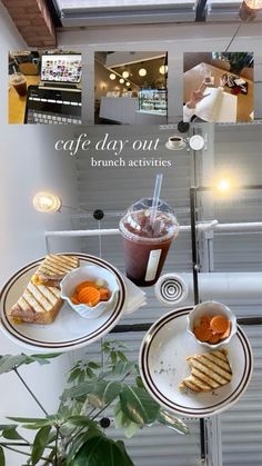 two plates with sandwiches and drinks on them sitting on a table in front of a window