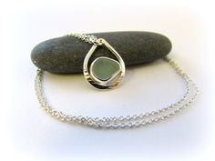 "Sea glass sterling silver necklace with bezel sea glass. Small teardrop sea glass pendant. A tiny simple silver handmade pendant. Beachy Maine gift. Our PETITE sea glass teardrop necklace features a uniquely shaped piece of sea glass securely bezel set in fine silver, and settled into a silver teardrop handmade in our Maine studio. A completely handmade process, we first manipulate recycled silver wire into an organic shape, be it circle, teardrop, oval or marquise, then solder each shape close Silver Teardrop Sea Glass Jewelry, Maine Gifts, Sea Glass Pendant, Sea Glass Necklace, Argentium Silver, Teardrop Necklace, Recycled Silver, Handmade Pendant, Recycled Sterling Silver