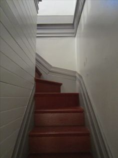 a set of stairs leading up to a skylight