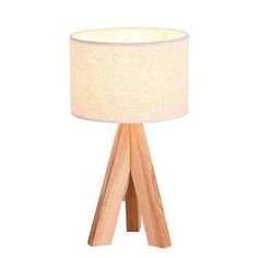 a wooden table lamp with a white shade