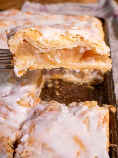 a close up of a piece of cake on a pan with a fork in it