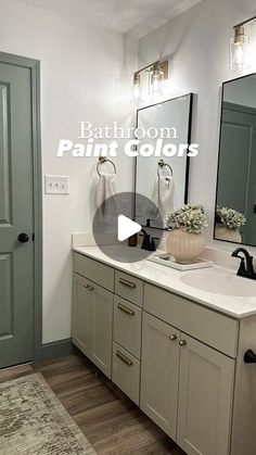 a bathroom with gray cabinets and white counter tops is featured in this video about painting colors