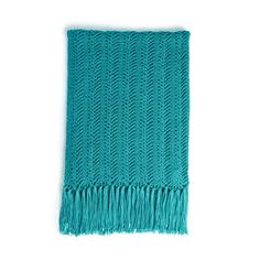 a green knitted blanket with fringes on the bottom and one end in blue