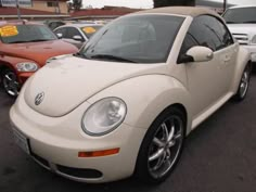 a white car parked in a parking lot next to other cars