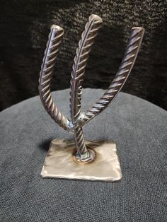 a decorative metal object on a cushion