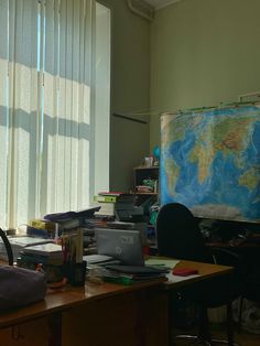 an office with a large map on the wall and desks in front of it