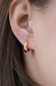 A chubby silhouette lends pillowy dimension to these dainty sterling silver hoop earrings plated in warm 18-karat gold. 5/8" hoop diameter; 1/4" width Hinge with snap-post closure Sterling silver/18k-gold plate Imported Small Huggie Hoop Earrings, Everyday Gold Earrings Indian, Small Gold Hoop Earrings Aesthetic, Simple Small Hoop Earrings, Gold Hoop Earrings Aesthetic, Pure Gold Earrings, Small Hoops Earrings, Small Hoop Earrings Gold, Simple Ring Design