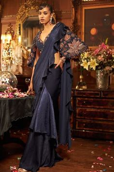 Midnight blue blouse with all over floral pattern, contrast sequins, crystals, zari, beads, dabka and dori hand embroidery. Paired with pre-draped saree with attached pallu, pleated cowl draped details and ruffle border. - Aza Fashions Party Wear Blouse With Mirror Work For Eid, Silk Choli For Eid Evening Events, Silk Blouse For Evening And Eid, Party Embroidered Georgette Blouse, Party Blouse With Zari Work For Eid, Floor-length Blouse For Diwali Party, Traditional Drape Embroidered Blouse For Parties, Eid Party Blouse With Zari Work, Elegant Brocade Pre-draped Saree For Designer Wear