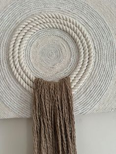 a wall hanging made out of rope and yarn