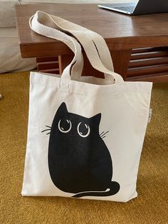 Cat Tote Bags Ships from California within 24 hours of ordering Made in USA organic cotton bags Message me with any questions Casual Everyday Cat Print Bag, Black Bag With Cat Design As Gift, Everyday Black Bag With Cat Print, Daily Use Cotton Bags With Cat Design, Cotton Bags With Cat Print For Everyday Use, Black Everyday Bags With Cat Print, Black Cat Print Bag For Gift, Black Bag With Cat Print For Gift, Gift Black Bag With Cat Print