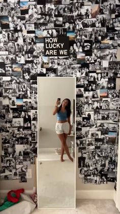 a woman taking a selfie in front of a mirror with many pictures on it