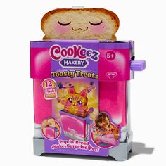 a toy toaster with a stuffed animal in it's front and the lid open