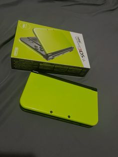 the box is open and it has a green cover on it, with an image of a cell phone sitting next to it