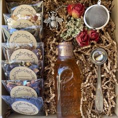 a box filled with lots of different types of items next to flowers and spoons