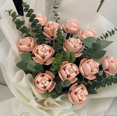 a bouquet of pink flowers sitting on top of a table