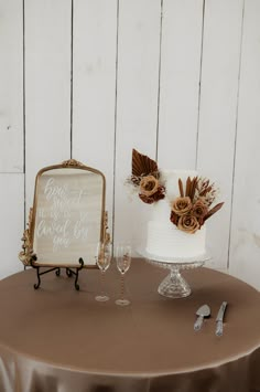 a table topped with a white cake covered in frosting