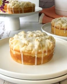 two cakes sitting on top of white plates covered in icing