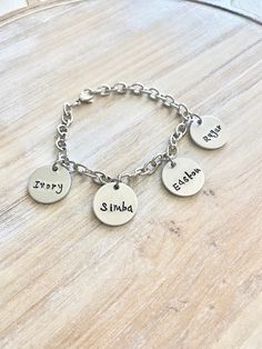 "Mother Charm Bracelet Grandma Charm Bracelet Grandchildren Name Bracelet Handstamped Bracelet Personalized Bracelet Handstamped Jewelry Handstamped charm bracelet with \"Names of Choice\". This bracelet makes a loving gift to any member of your family or friends. *3/4\" Aluminum disc stamped with \"Names of Choice\" * A stainless steel chain charm bracelet. Samples shown are stamped in 3mm Tootsie at check-out, please leave information **names **length of chain desired All handstamped jewelry i Personalized Metal Bracelets, Hand Stamped Silver Metal Bracelets, Stamped Round Bracelet As A Gift, Nickel-free Round Charm Bracelet For Friendship, Adjustable Stamped Name Bracelet For Friendship, Adjustable Hand Stamped Charm Bracelet For Everyday, Nickel-free Charm Bracelet For Friendship, Nickel-free Metal Bracelets For Birthday, Personalized Round Metal Charm Bracelet