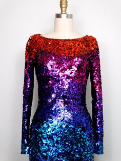 "Another colorful dress! Fully embellished with vibrant sequins all over in an ombre rainbow design. There's a bit of stretch in the material, so measurements are taken unstretched and stretched. It's in perfect condition! Size 4 measurements: Bust - 32/34\" Waist - 25/27\" Hips - 34/36\" Dress Length - 33\" Tag Size - 4 Size 8 measurements: Bust - 36/38\" Waist - 28/30\" Hips - 38/40\" Dress Length - 34\" Tag Size - 8 This dress comes from a pet-free and smoke-free home. If you would like more Glamorous Multicolor Long Sleeve Sequin Dress, Multicolor Contrast Sequin Party Dress, Multicolor Contrast Sequin Dress For Party, Summer Party Dress With Rainbow Print, Fitted Rainbow Print Dress, Multicolor Sequined Disco Dresses, Multicolor Fitted Party Dress, Multicolor Disco Style Party Dress, Disco Style Multicolor Party Dress