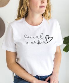 This t-shirt is perfect for any social worker who wants to show off their passion for their profession. The design is carefully crafted to resemble a handwritten script, giving it a personal touch that sets it apart from other generic t-shirts. The heart symbolizes the love and care that social workers have for their clients, making it a powerful statement piece. With six different color options to choose from, including white, ash, natural, black, navy, and pink, you're sure to find a shade tha Basic Cotton T-shirt For Work, Basic White T-shirt For Work, Cotton Tops With Branding For Workwear, Workwear T-shirt With Text Print And Short Sleeves, Graphic Print Crew Neck T-shirt For Work, Social Worker Gifts, Social Workers, White Ash, Social Worker