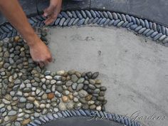 a man is placing rocks on the ground