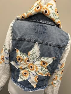 a denim jacket with sunflowers on it