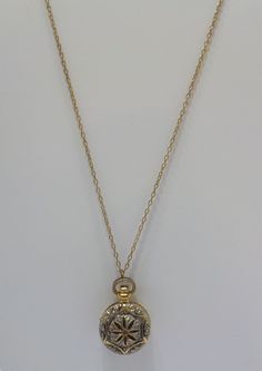 "Vintage 1928 brand pocket watch style locket pendant. 28\" chain with barrel fastener. Gold tone pocket watch style locket, including bale is 1 1/4\" x 3/4\". Hinged locket holds two photos. Gorgeous filigree design on the front of the locket & gold tone trim around the outer edge on the backside. This is in excellent vintage condition. Pre-owned & gorgeous! Signed with 1928 hang tag." Timeless Medallion Locket Necklace For Formal Occasions, Classic Vintage Charm Locket Necklace Collectible, Classic Gold Pocket Watch With Locket, Gold Pocket Watch With Locket, Classic Gold Medallion Pocket Watch, Vintage Locket Necklace As Keepsake, Timeless Gold Locket Necklace For Formal Occasions, Gold Timeless Locket Necklace For Formal Occasions, Antique Gold Pocket Watch With Locket For Formal Occasions