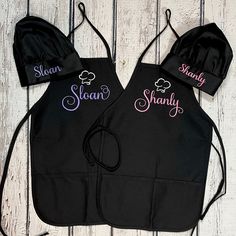 two personalized aprons are shown on a white wood background with the name shanny and shanny