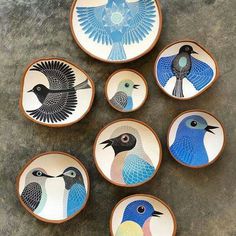 six plates with birds painted on them