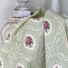 a bed covered in a green and white bedspread