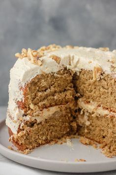 a cake with white frosting and walnuts cut in half to show the inside