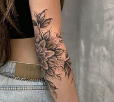 a woman with a sunflower tattoo on her arm