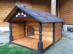 a dog house made out of wooden boards