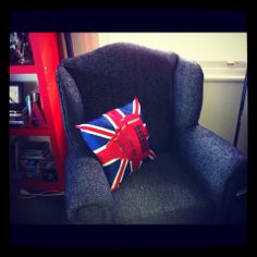 a blue chair with a union jack pillow on it