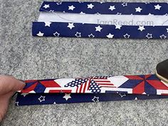 a pair of red, white and blue belts with stars on them are being held by someone's hand